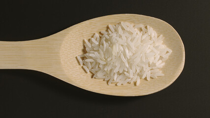 TOP VIEW: Rice appears in wooden spoon