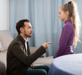 Father and mother telling off their daughter for disobedience