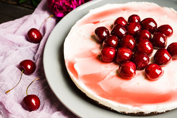 Fresh cheesecake with cherries on the rustic background. Selective focus. Shallow depth of field.