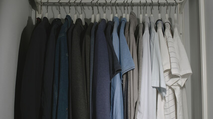 Wardrobe is filled with clothes in the room