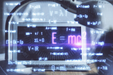 Desktop computer background and formula hologram writing. Double exposure. Education concept.