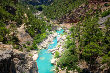 Fototapeta na wymiar Emerald color mountain river flows through a gorge. Ermenek river, Mersin province, Turkey