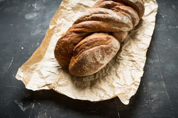 Freshly baked rustic bread on the rustic background. Selective focus. Shallow depth of field.
