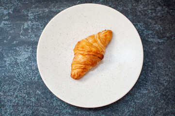 croissant on a plate. top view. flat lay concept