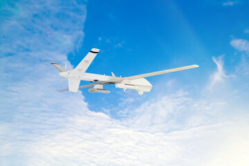 Fototapeta na wymiar military RC military drone flies against the backdrop of blue peaceful sky with white clouds