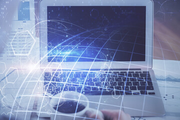 Multi exposure of table with computer and world map hologram. International data network concept.