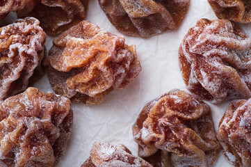 Dried persimmon on white crumpled paper. Top view, macro.