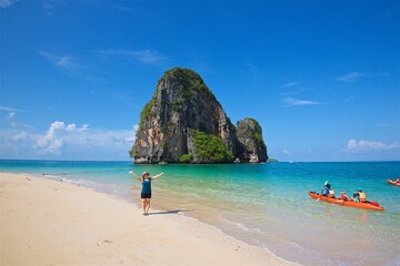 Fototapeta premium photo taken on a wide angle lens, girl on the shore of the azure sea in Thailand, the transparent sea, a picturesque island, paradise pleasure, travel and vacation