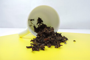   used tea leaves and inverted cup 