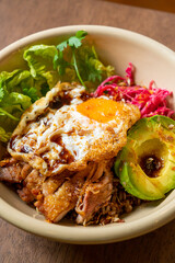 rice with fried chicken teriyaki sauce and avocado and fried egg