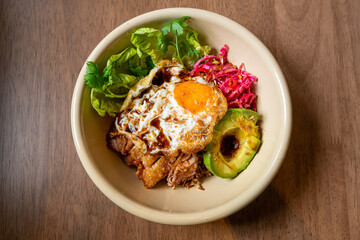 rice with fried chicken teriyaki sauce and avocado and fried egg