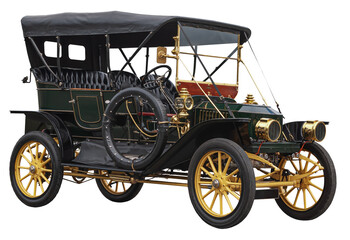 A dark green steam-powered vintage car from the early twentieth century. This old vehicle has a black fabric canopy, polished brass lamps and trim and yellow painted wheels.