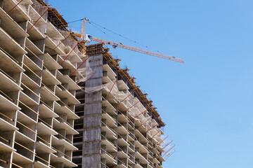 tower crane at a building site during the construction of blocks of flats. Detail of residential...