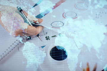 Double exposure of Man writing in notepad with business icons on background.