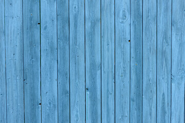 Blue wooden background, old age effect. Old boards painted light blue, close-up.
