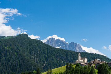 Ancient church dedicated to Saint Lucy in Colle Santa Lucia, with a breathtaking view over the Civetta mountain, Dolomites (IT)