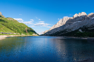 Fototapeta na wymiar Lago Fedaia (Fedaia Lake), Fassa Valley, Trentino Alto Adige, an artificial lake and a dam near Canazei city, located at the foot of Marmolada massif. Fedaia Lake is the Province of Belluno, Italy.