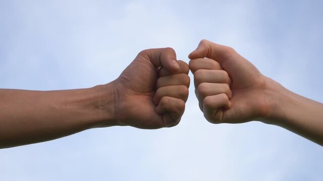 Business concept of teamwork. Close-up of the fists touching the symbol of a successful transaction, cooperation. Two successful people shake hands, a business group handshake.