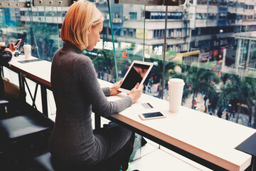Businesswoman is reading world news on touch pad with copy space screen for your advertising text...