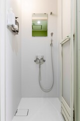 Obraz premium Empty corner rounded shower cabin with closed sliding glass door