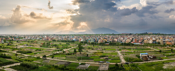 Panorama of plotted land for building houses nearby airport and dense settlement of Kathmandu. The...