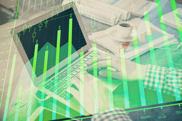 Double exposure of forex graph with man working on computer on background. Concept of market analysis.