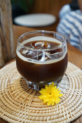 Close up glass of iced black Americano coffee on wooden tray table