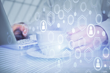 Social network theme hologram with businessman working on computer on background. Multi exposure.