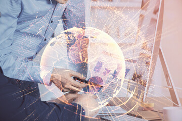 Social network theme hologram with businessman working on computer on background. Multi exposure.