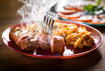 Sausage with beans on a plate.