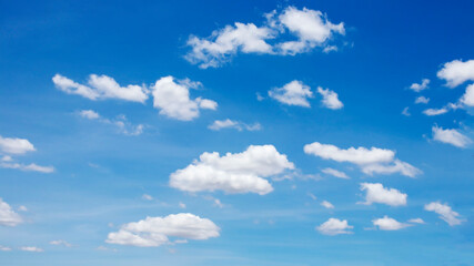 Naklejka na ściany i meble Many blurred white clouds on the beautiful blue sky for use as a background image.