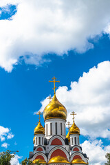 Golden domes of christian church in Moscow. Beautiful blue sky background.