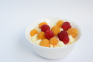 Homemade red and yellow raspberry cheese in a white plate
