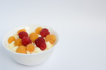 Homemade red and yellow raspberry cheese in a white plate

