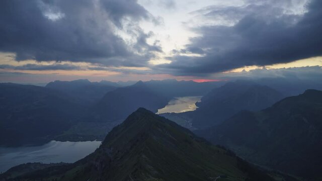 The beautiful misty mountains of Morgenberghorn, Switzerland during the summer sunset - time lapse