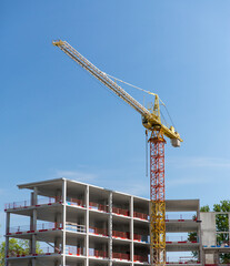 architecture and urban concept - building crane on construction site