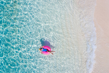 Top above high angle aerial drone view of her she attractive girl floating on rubber ring in...