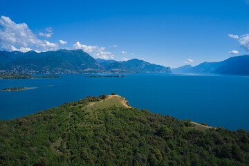 Fototapeta na wymiar Lake Garda, Italy. Aerial view of punta sasso, rocca di manerba in the background mountains, garda island at high altitude