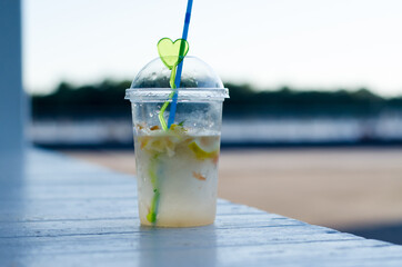 Lemon and grapefruit drink on a white wooden table against the background of nature. Fruit Mojito.