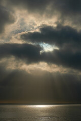 Clouds with rays of the sun over the sea. Selective focus