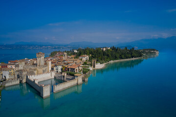 The famous Sirmione Castle, good weather. Aerial view of the castle. Castle reflections in the water Sirmione, Lake Garda, Italy.