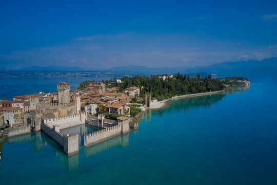 The famous Sirmione Castle, good weather. Aerial view of the castle. Castle reflections in the water Sirmione, Lake Garda, Italy. © Berg