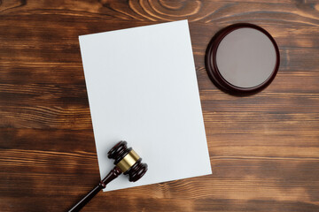 Hammer judges on a wooden background with a copy of space on paper and top view.