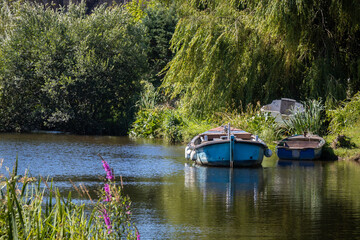 Fototapeta na wymiar Blue boats on the river
