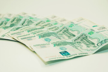 One thousand rubles cash banknotes lie on a white background
