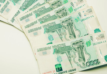 One thousand rubles cash banknotes lie on a white background