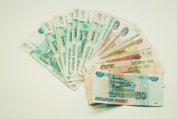 Money notes of one thousand, five hundred, one hundred and fifty rubles are on a white background