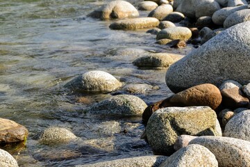 Huge stones on the river bank. River stones and clean, clear water of the river. Bialka River, Poland
