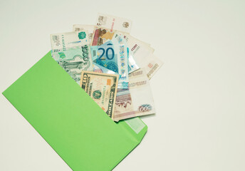 Money paper notes of different countries lie in an envelope
