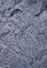 Rough surface of a old granite boulder. Abstract pattern of raw granite. Stone texture. 